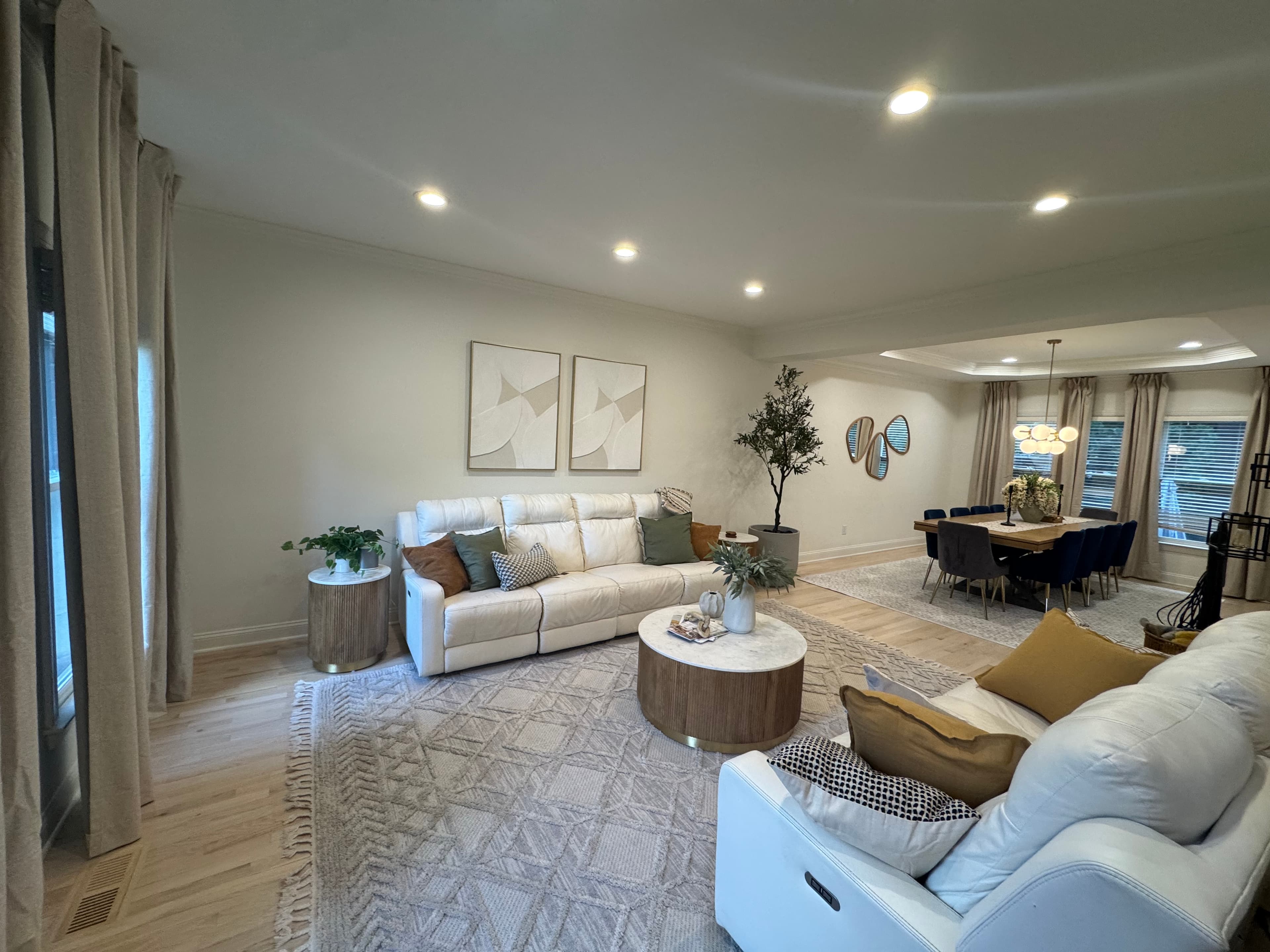 Open-plan full home remodel in Charlotte with warm neutral walls and hardwood floors.