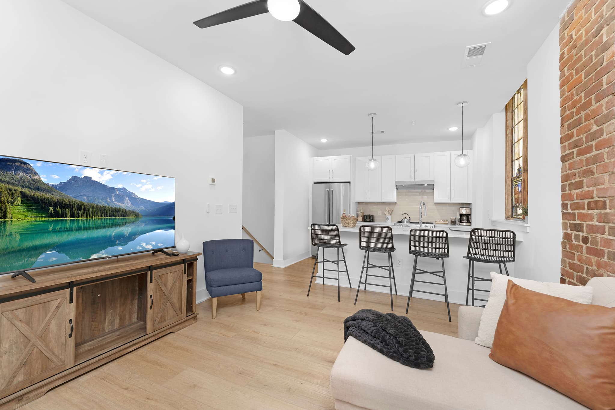 Open-plan Charlotte remodel with bright white walls and new flooring.